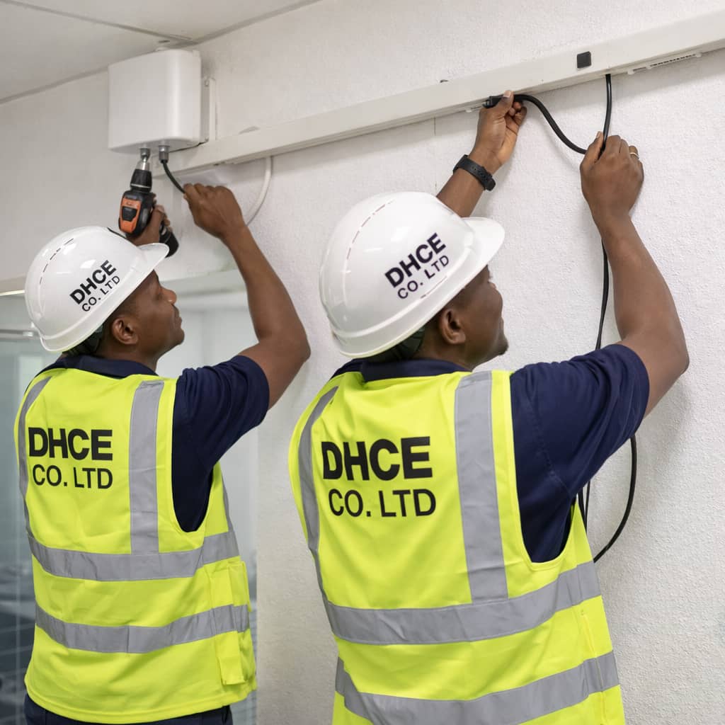 DHCE Services engineer installing and configuring GSM signal booster equipment to enhance network signal strength in a facility