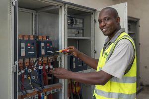 DHCE engineer inspecting and maintaining an electrical control panel to ensure safe and efficient system operation.