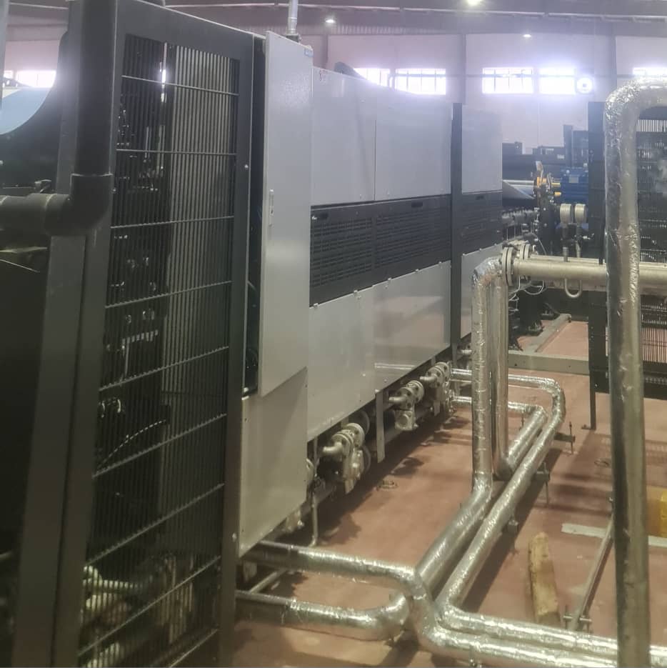 DHCE Services engineer installing pipe fittings and mechanical systems equipment in a professional engineering environment.