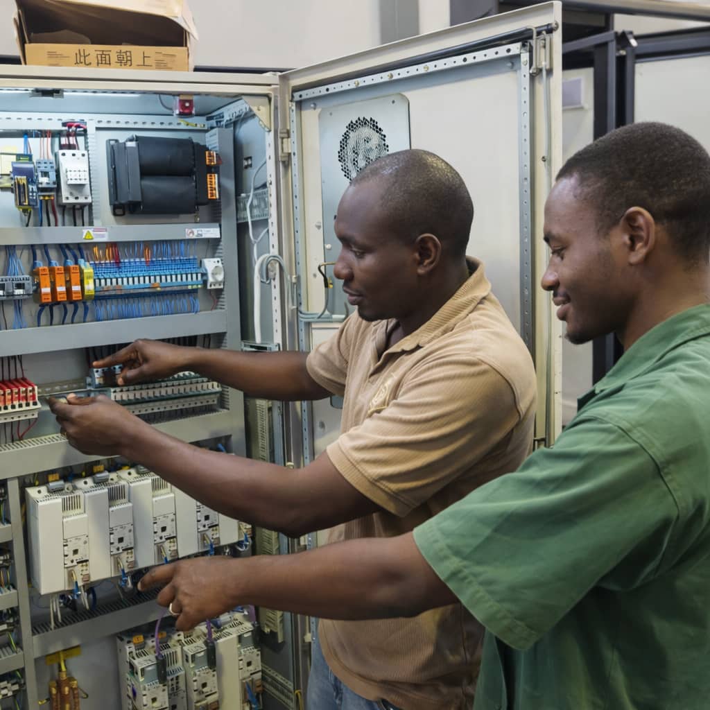 DHCE Services engineer performing electrical and mechanical installation and system configuration in a professional engineering environment